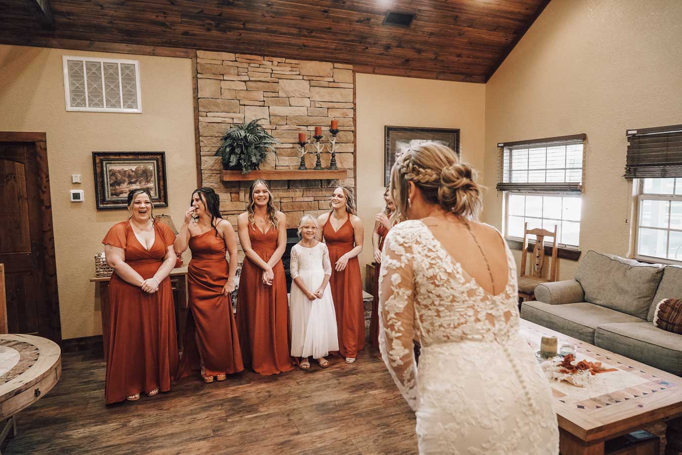 Bride getting ready with bridesmaids inside the Willowood Ranch bridal suite with fireplace and natural light