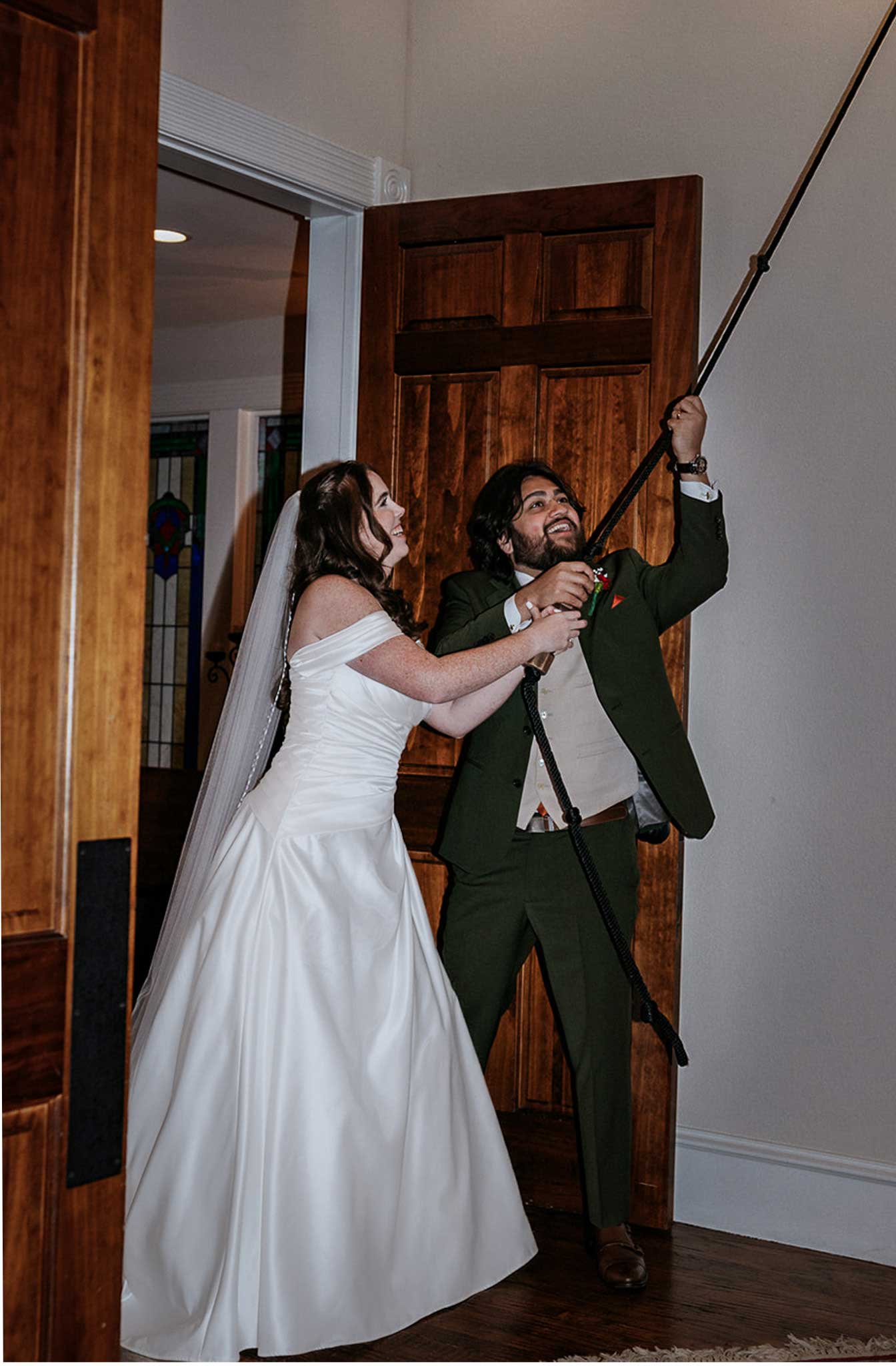 Bride and groom ringing chapel bell together at Willowood Ranch wedding venue in Bells Texas near Dallas