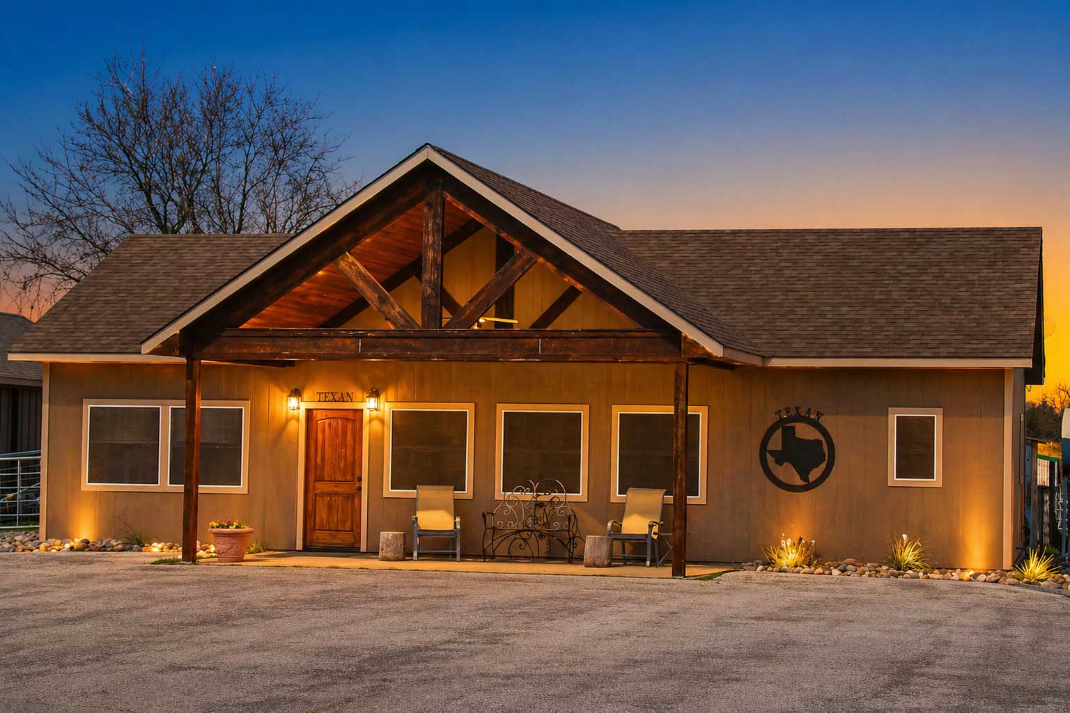 Exterior of Willowood Ranch lodge at sunset with warm lighting and rustic architecture