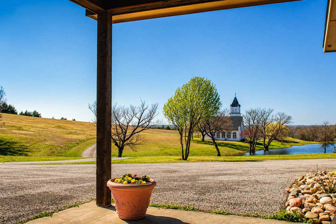 Scenic view of Willowood Ranch chapel and pond from the lodge porch