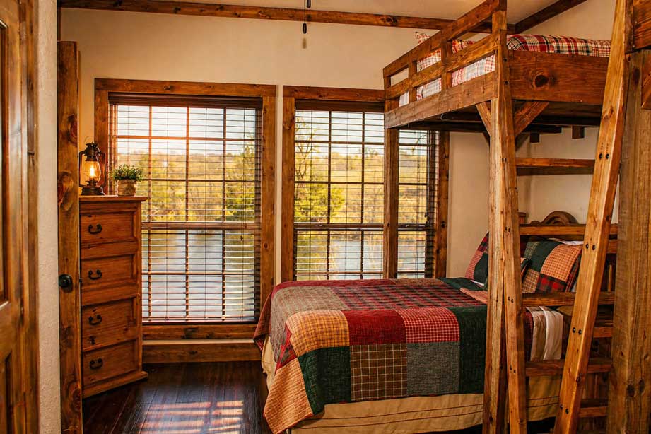 Rustic bunk room at Willowood Ranch cabin with wood finishes and large windows