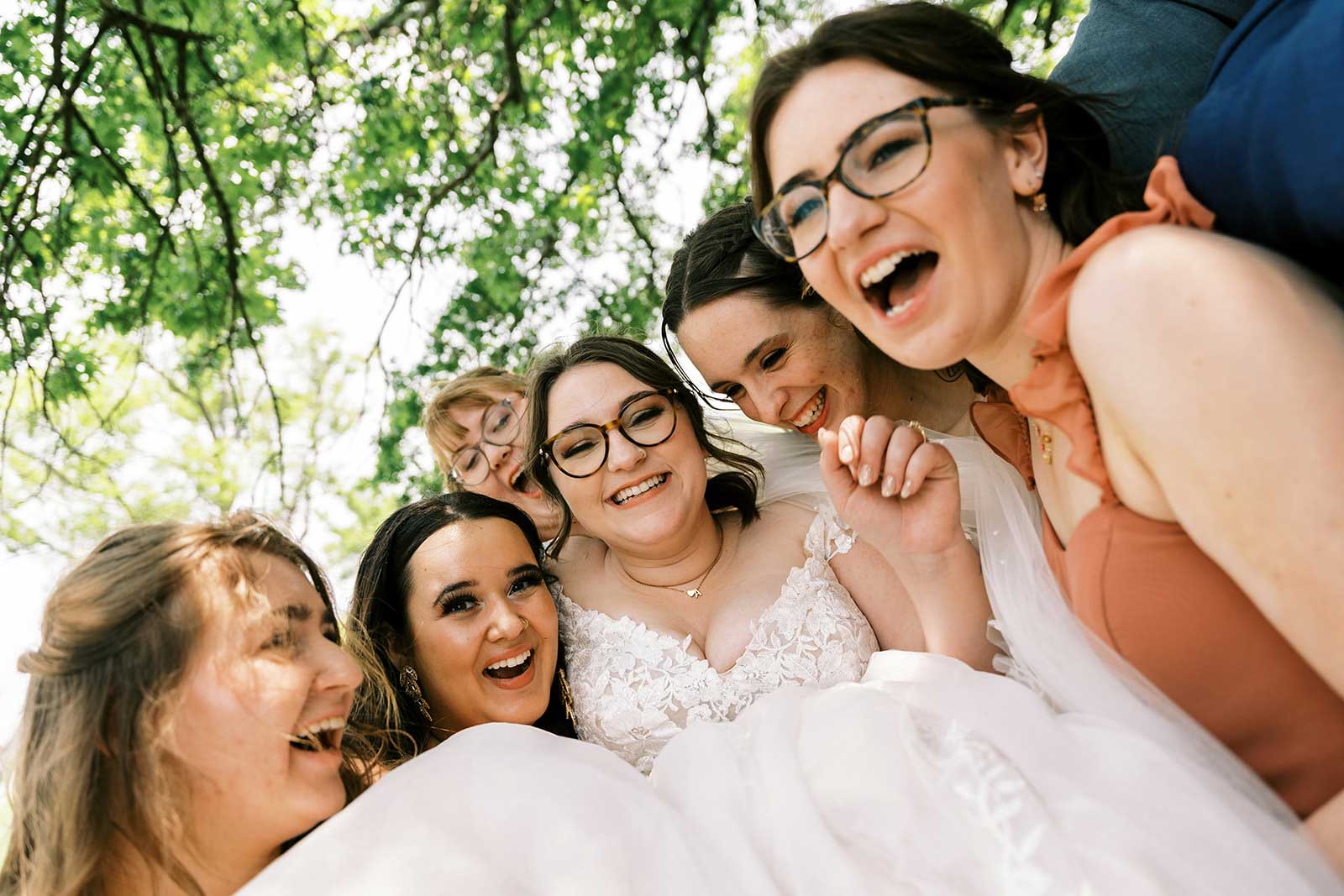 Bride laughing with bridesmaids during outdoor wedding celebration at Willowood Ranch in North Texas