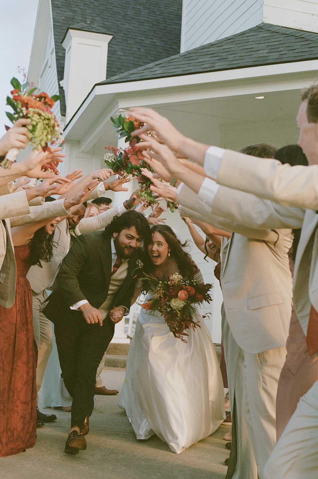 Bride and groom exiting chapel at Willowood Ranch in Bells Texas surrounded by wedding guests celebrating