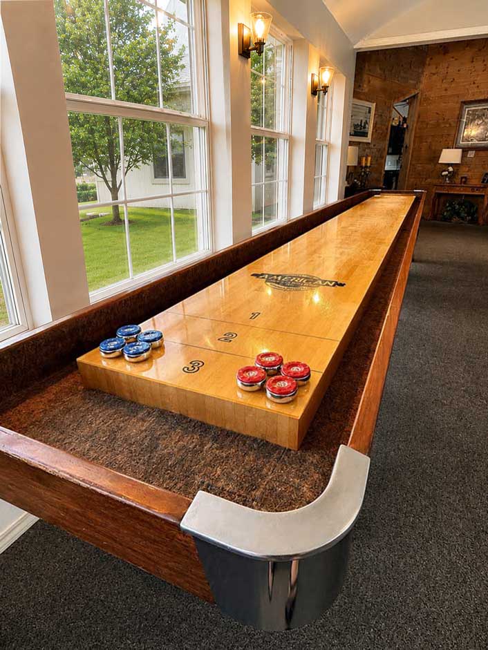 Shuffleboard table inside The Ranch House game room at Willowood Ranch in Bells, Texas.