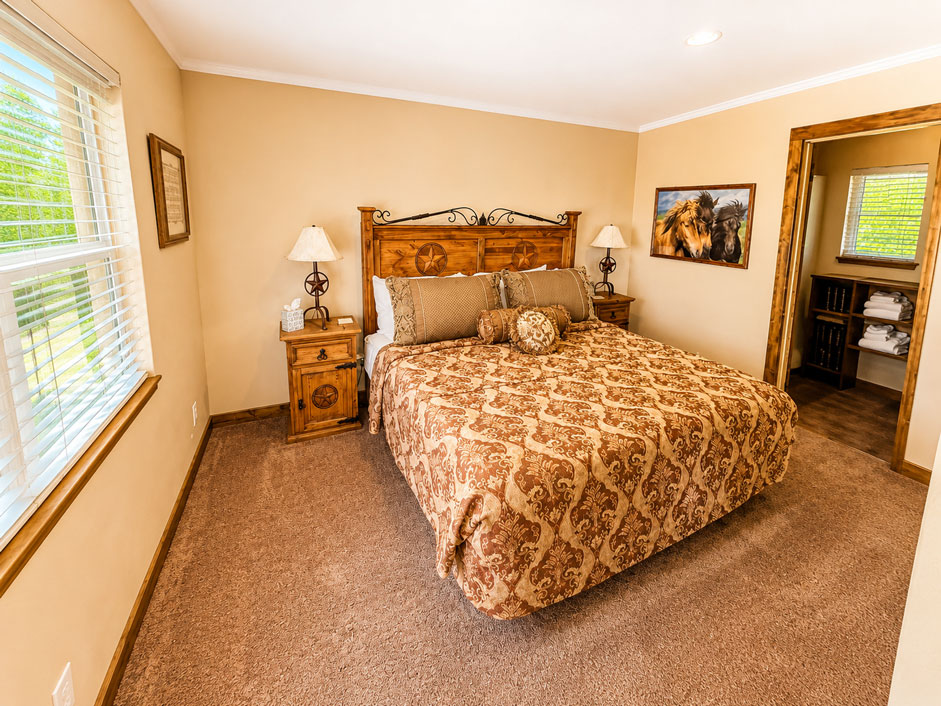 Primrose king bedroom with ensuite bathroom at The View on Willowood Ranch in Bells, Texas
