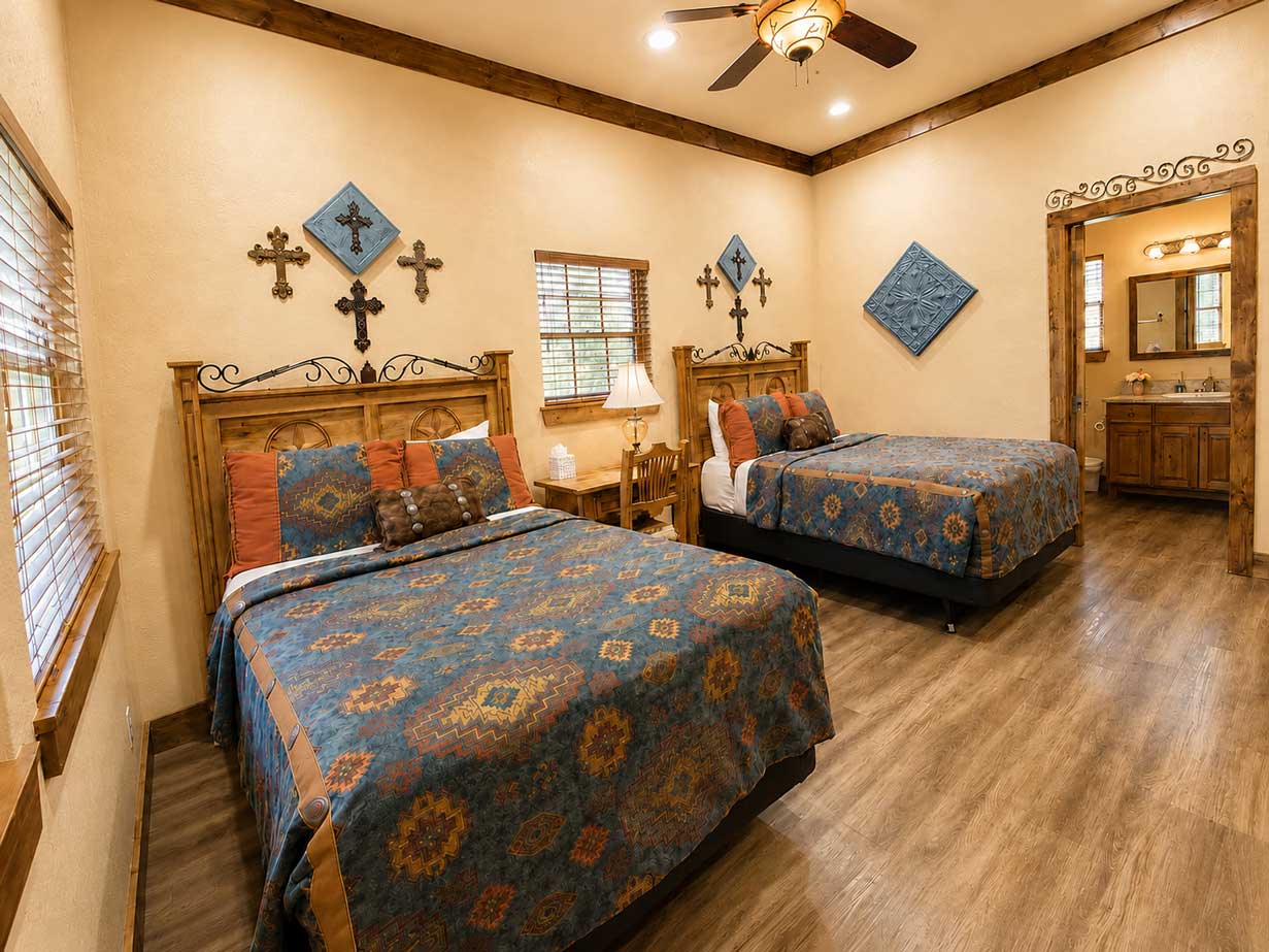 Guest bedroom inside the Lone Star cabin featuring comfortable accommodations, rustic furnishings, and western-inspired décor.